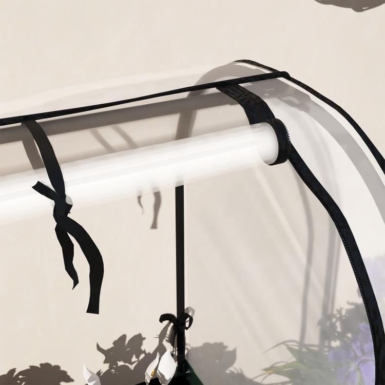 Covered raised garden bed frame with clear plastic cover and black metal bars