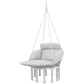 Gray macrame hanging hammock chair with thick padded cushion and rope fringe