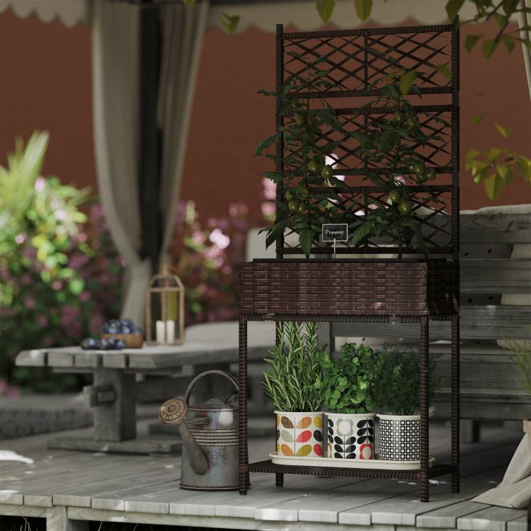 Brown wicker planter stand with trellis and lower shelf, styled with potted plants