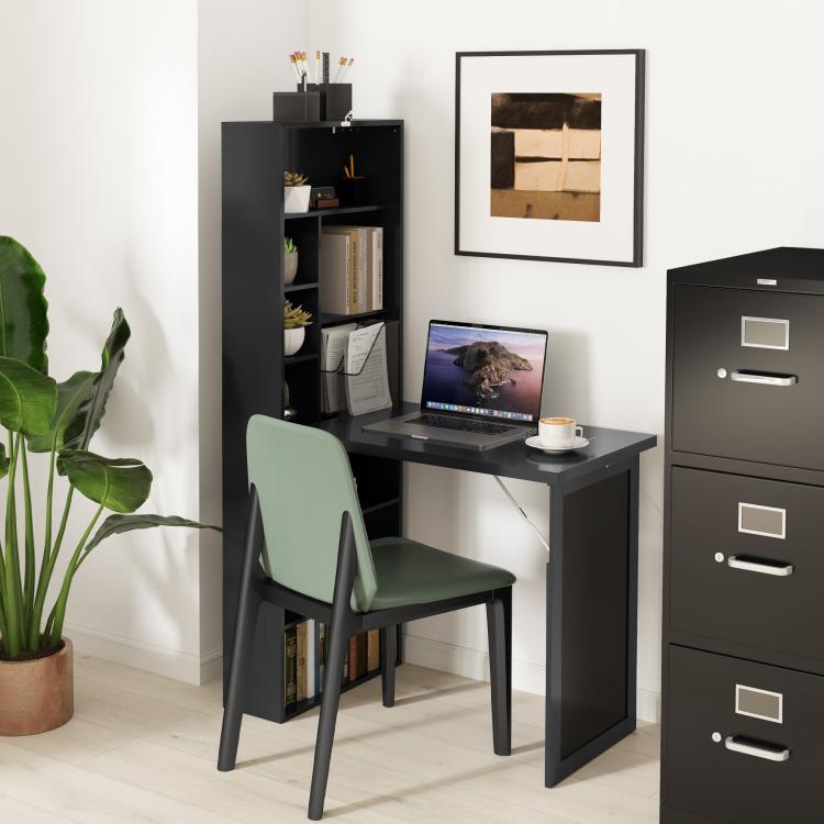 Black wall-mount fold-out desk with open shelves and chair beside it