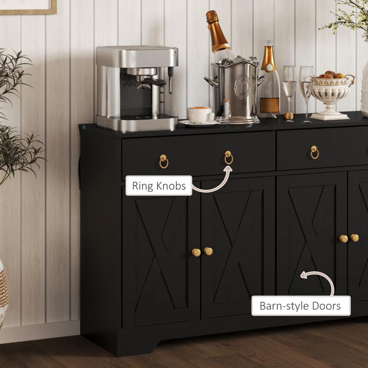 Black sideboard front detail with ring knobs and barn-style doors on cabinet storage.