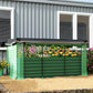 Green galvanized steel raised planter bed with crop cage panels and shade cloth across top