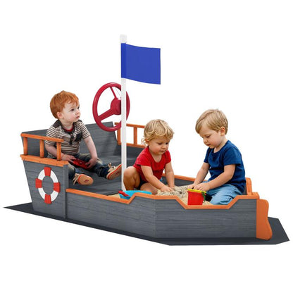 Kids wooden pirate ship sandbox with red wheel, blue flag, and bench seats
