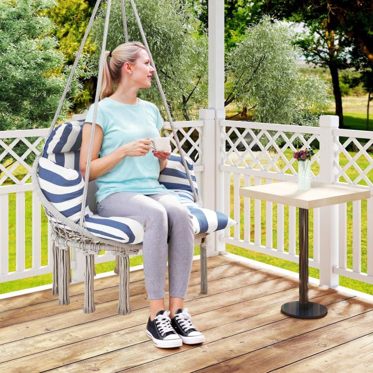 Macrame hammock swing chair in blue-and-white stripes with fringe tassels and cushion