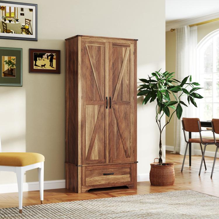 Brown tall pantry cabinet with barn-style doors, black handles, and bottom drawer