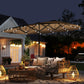 Khaki patio umbrella with LED lights over outdoor lounge seating at night