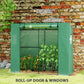 Green greenhouse with roll-up door and mesh screen panels for airflow