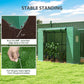 Green portable greenhouse anchored at the bottom edge with extended soil flap