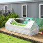 White galvanized raised garden bed with clear mini greenhouse cover outdoors