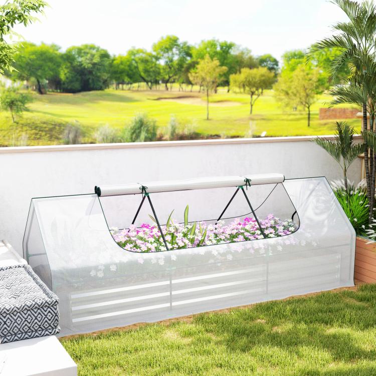 White raised planter with clear mini greenhouse cover and pink flowers inside