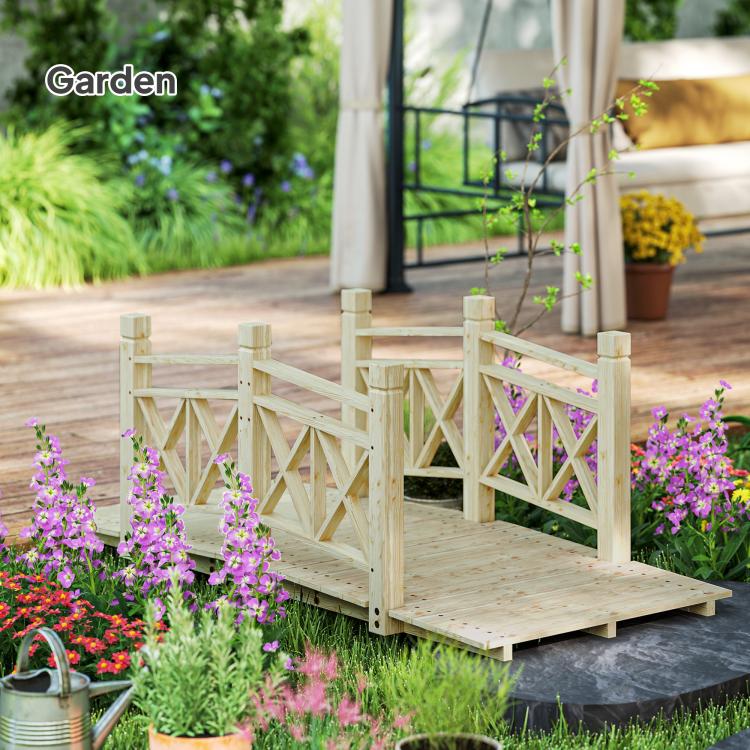 Wooden garden bridge footbridge with lattice railings and wide plank walkway