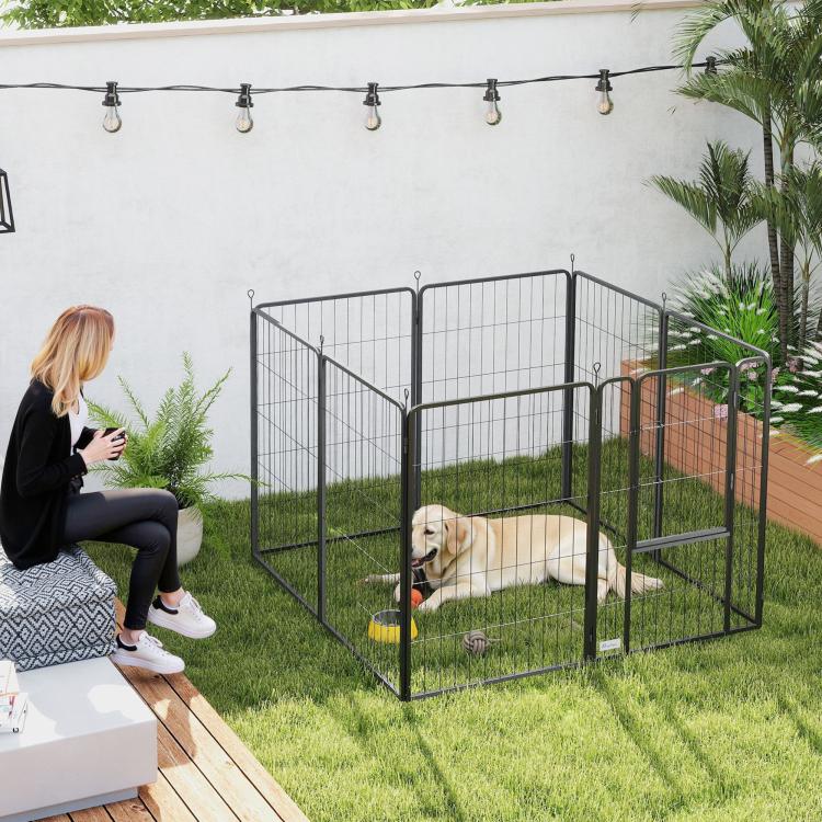Black metal dog playpen with arched top, dog inside, closed gate
