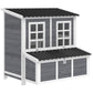 Wooden chicken coop with nesting box, front windows and dark shingle roof