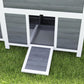 Wooden chicken coop with nesting box and pull-out tray, front tray open