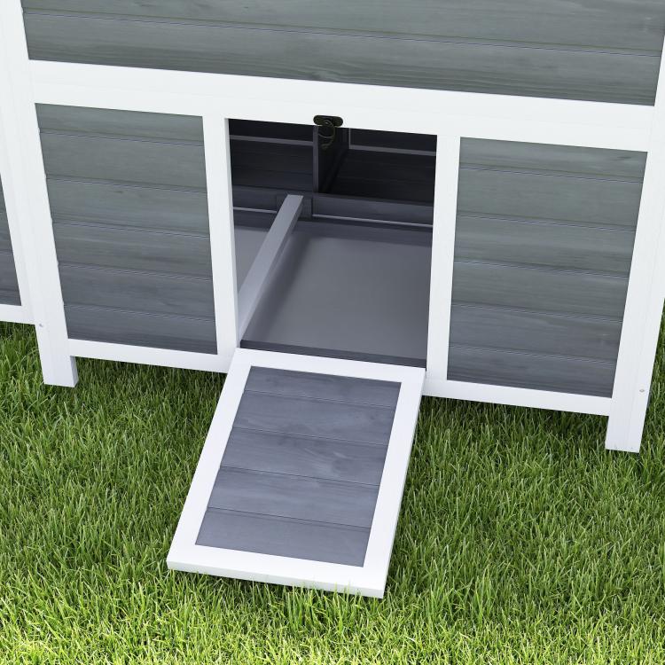 Wooden chicken coop with nesting box and pull-out tray, front tray open