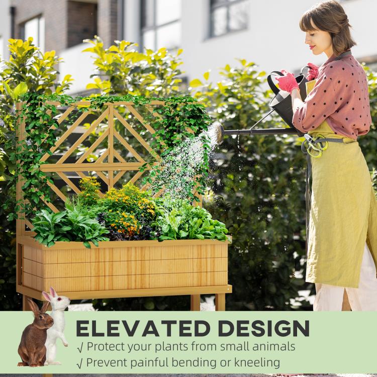 Wood raised planter with trellis and mixed flowers, watering with a garden hose