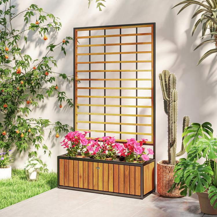 Wooden raised garden bed with trellis panel and pink flowers in the planter box
