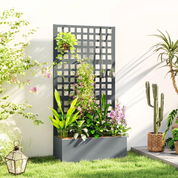 Gray raised garden bed planter with tall trellis panel and lush plants