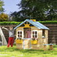Outdoor kids wooden playhouse with open door, flower boxes, and front windows