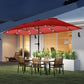 Wine red market umbrella with solar LED lights over an outdoor patio dining set