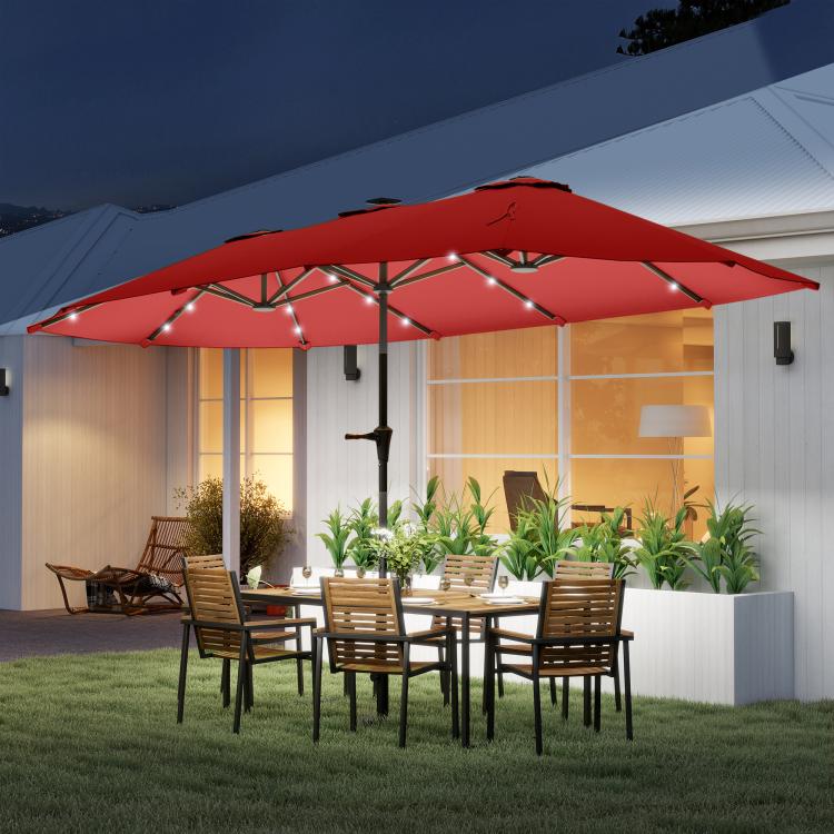 Wine red market umbrella with solar LED lights over an outdoor patio dining set