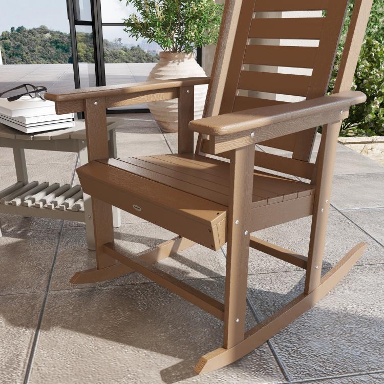Brown HDPE rocking chair with high backrest and wide armrests, visible seat deck