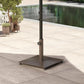 Brown metal umbrella base with central pole and four feet on tiled patio