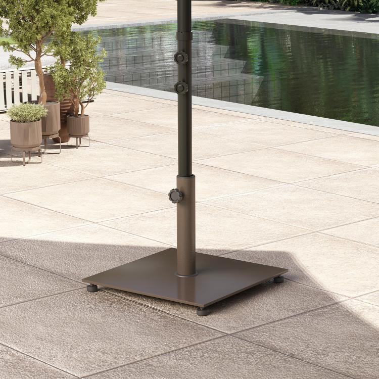 Brown metal umbrella base with central pole and four feet on tiled patio