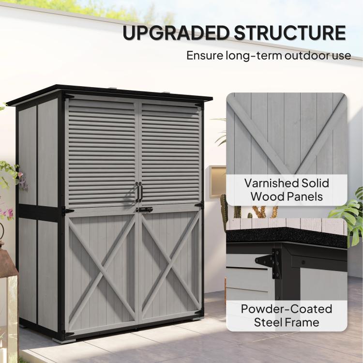Gray outdoor wooden shed with asphalt-style roof and cross-brace door panels