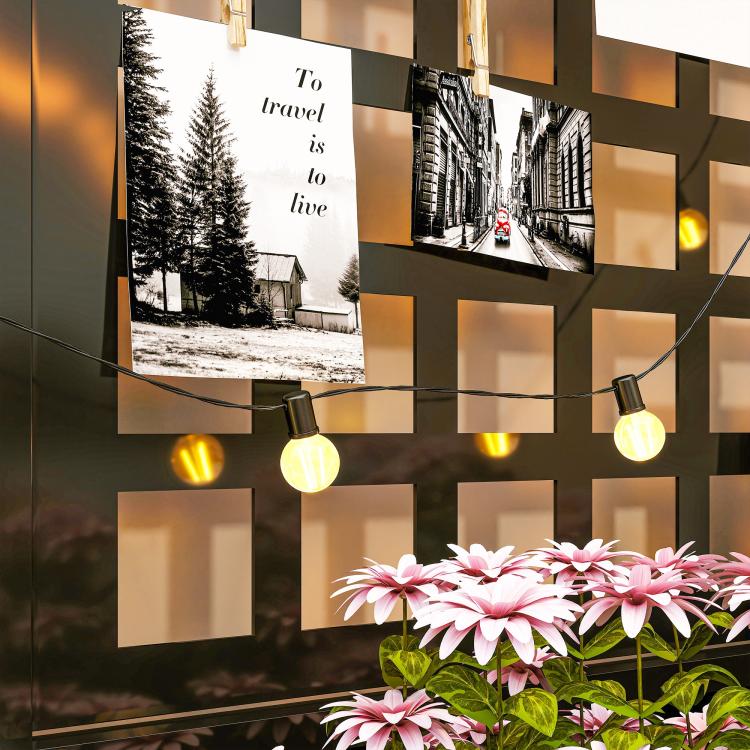 Outdoor flower display with pink blooms and string lights