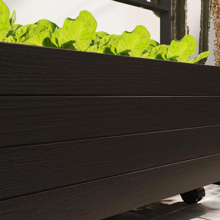 Raised garden bed planter with trellis and wheels, close-up of dark wood paneling