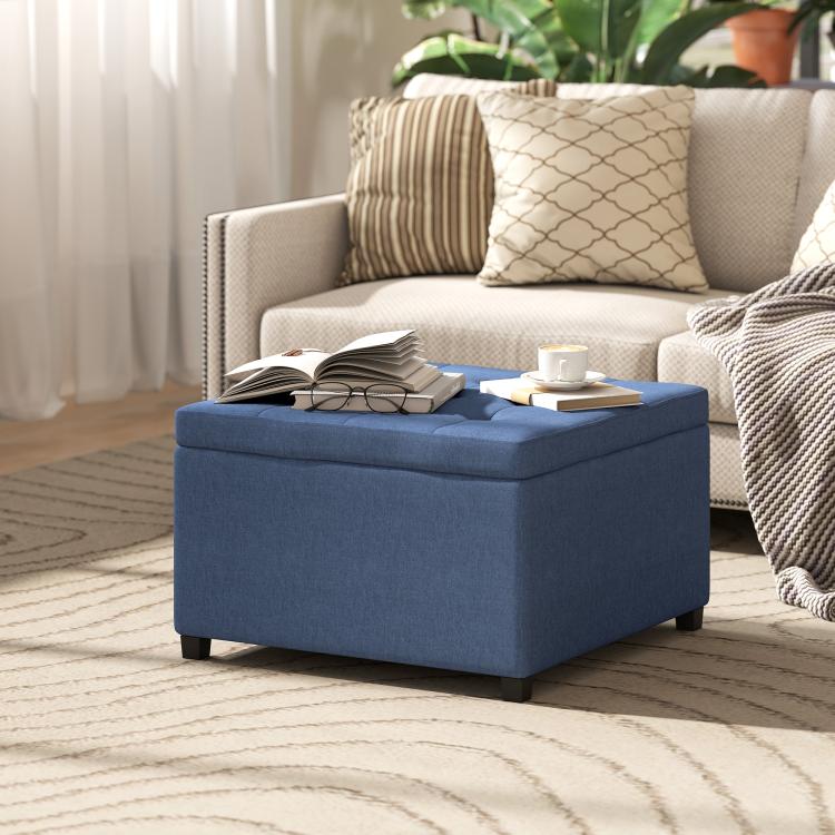 Blue storage ottoman with flip-top lid in a living room setting