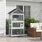 Gray wooden bird aviary with black roof and wire mesh enclosure on patio