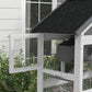 Bird aviary side view with black shingled roof and wire mesh panels