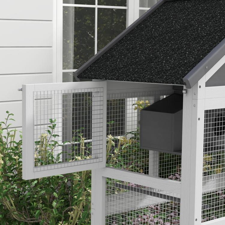 Bird aviary side view with black shingled roof and wire mesh panels