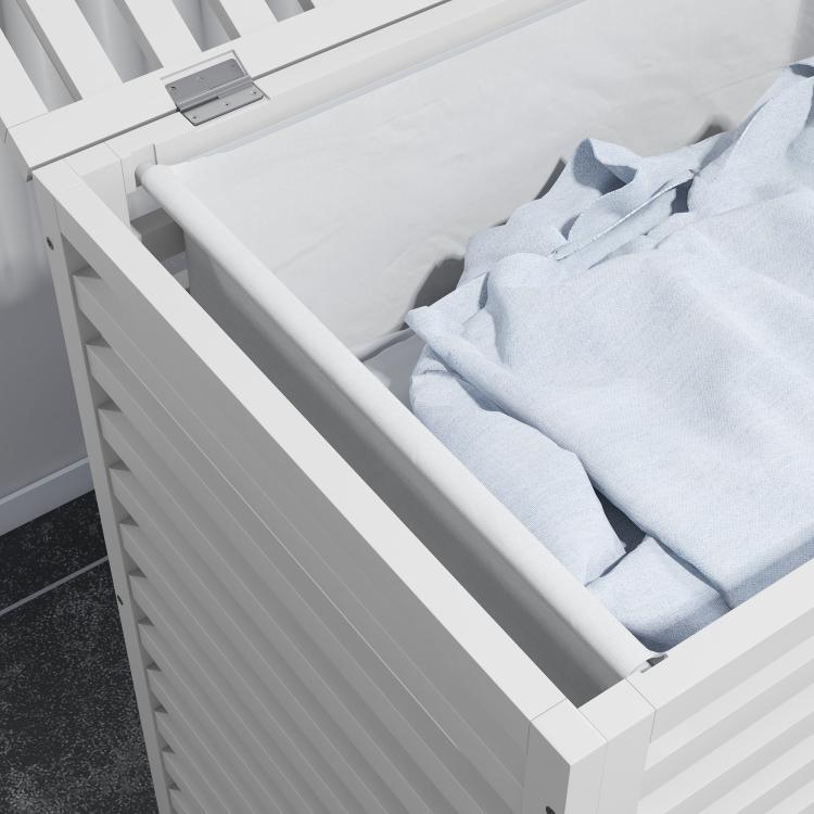 White slatted bamboo laundry hamper with inner liner bag, filled with folded clothes
