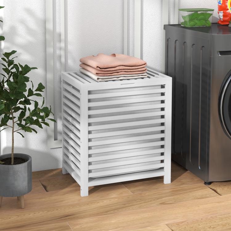 White slatted bamboo laundry hamper with lid holding folded towels