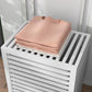 White slatted bamboo laundry hamper top with stacked folded towels