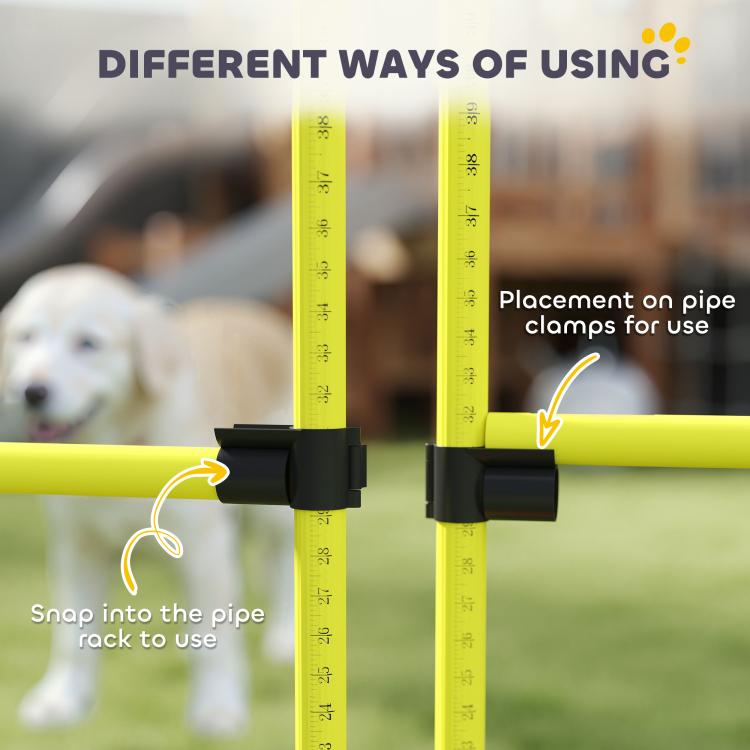 Yellow agility jump bar with black snap clamps and height measurement grooves, close-up