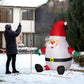 Inflatable Santa yard display with black boots, red suit stripes, and white belly light