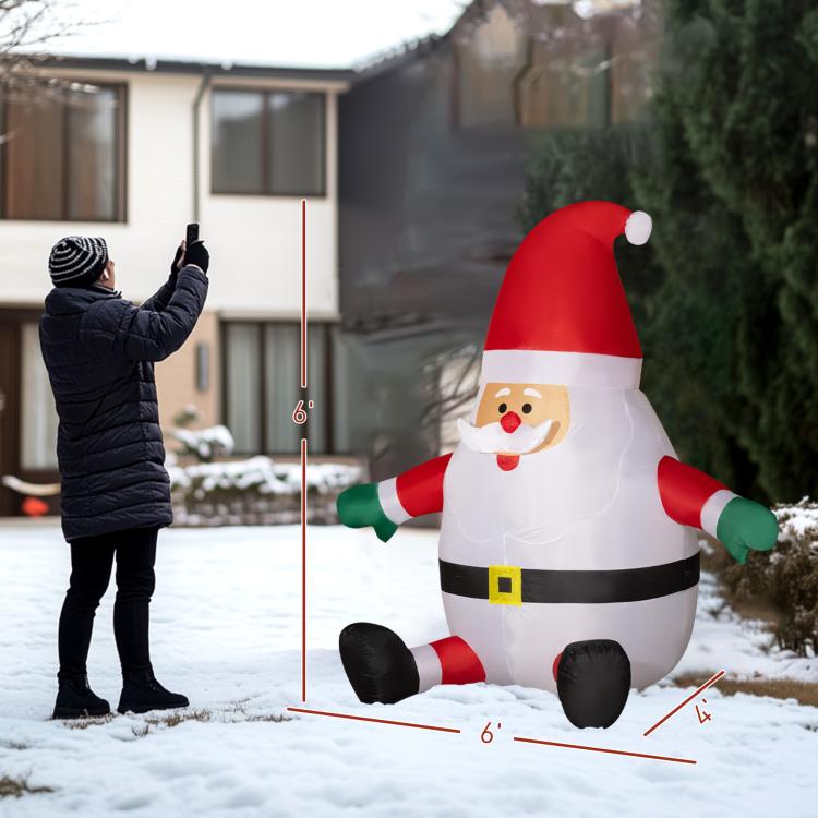 Inflatable Santa yard display with black boots, red suit stripes, and white belly light