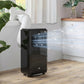 Black portable air conditioner with exhaust hose, freestanding on floor near window