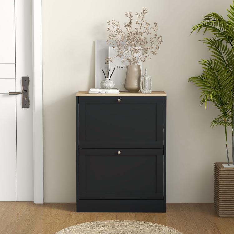 Black slim shoe storage cabinet with light wood top and two flip drawers, by door