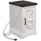 White side table with dark top, cabinet door, and charging cable with plug