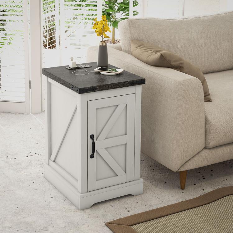 White distressed end table with black top next to sofa, featuring a front storage door