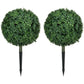 Two artificial boxwood ball topiary trees, green leaves, each with a ground stake