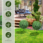 Artificial boxwood ball topiary tree with dense green foliage on a ground stake