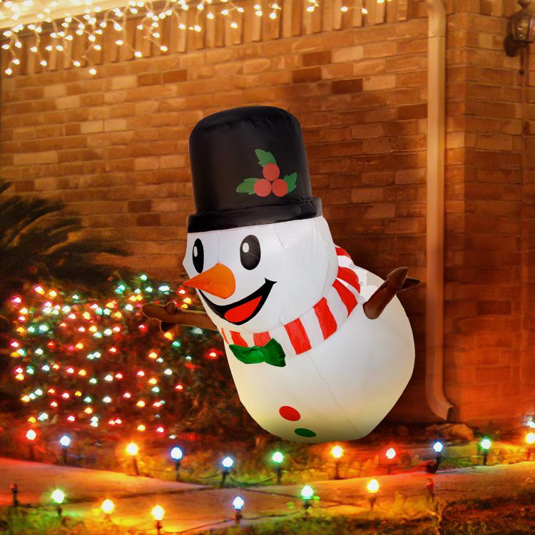 Inflatable snowman decoration with black top hat and red striped scarf, smiling face