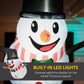 Close-up inflatable snowman face with glowing orange LED nose, black top hat