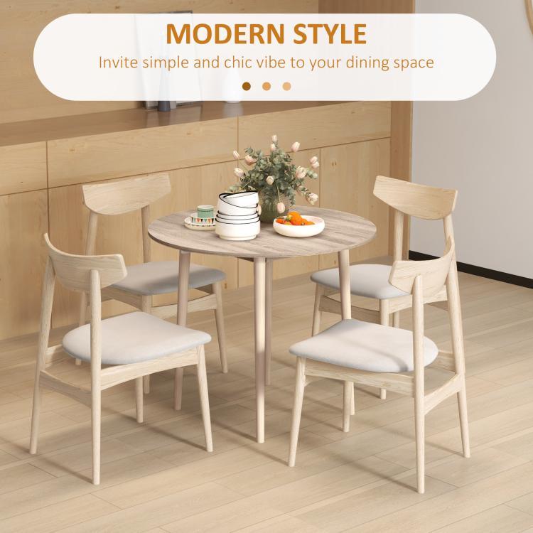 Modern round drop-leaf dining table in light oak finish with wooden legs and chairs